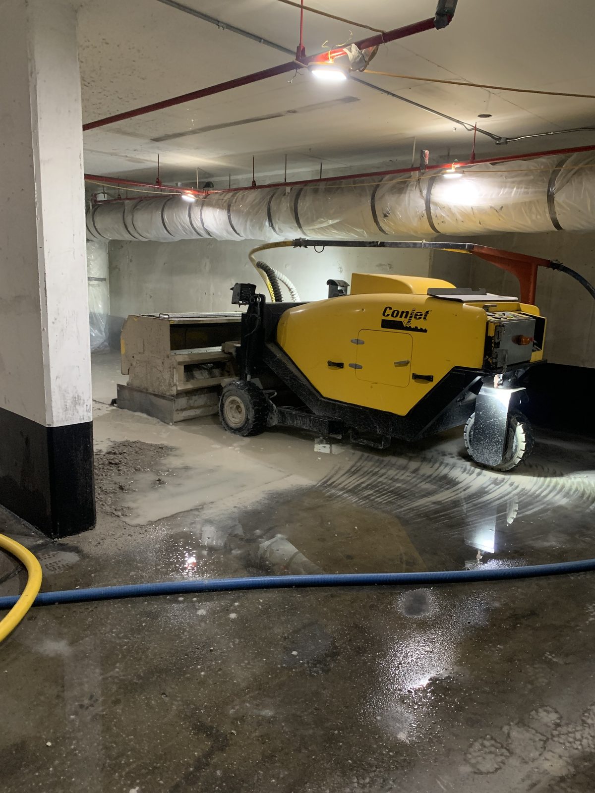 Conjet hydrodemolition robot positioned in an underground parking level